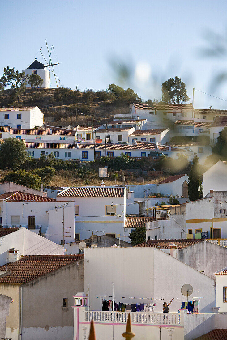 View of the village, windmill and white painted houses on a hill, Odeceixe, Algarve, Portugal