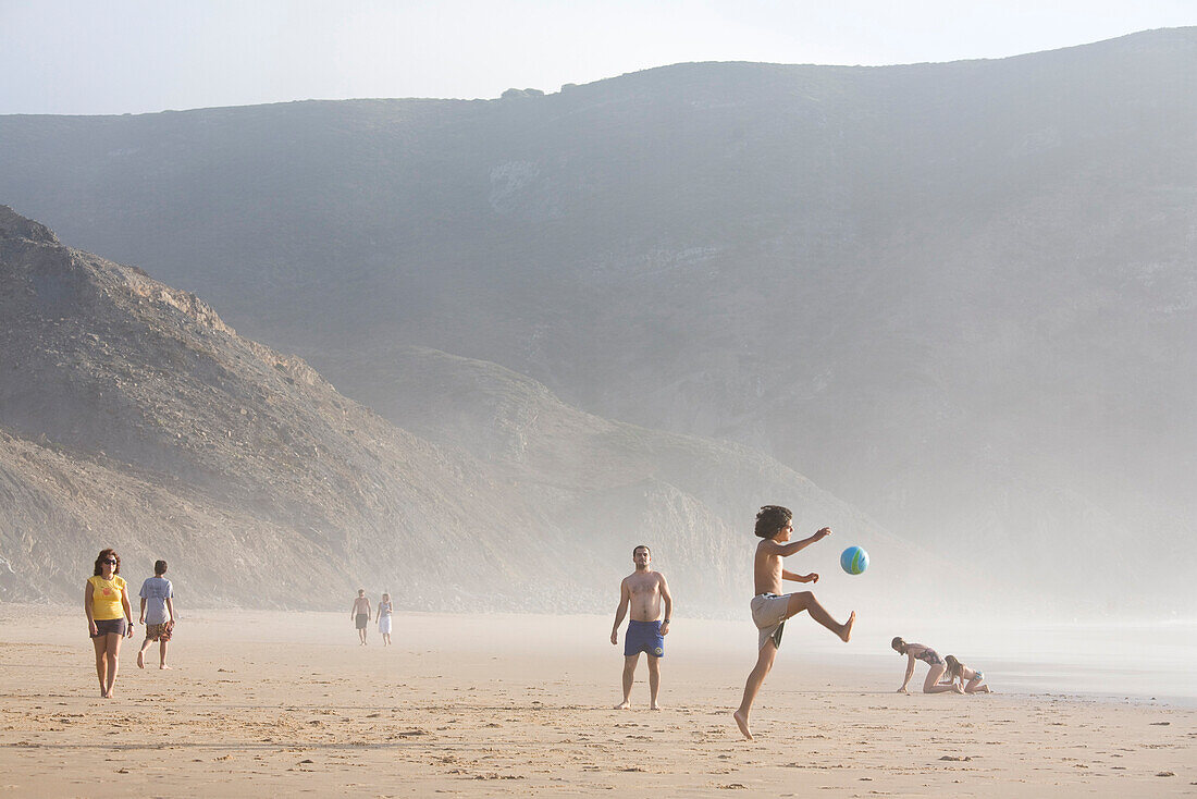 Children playing football on the beach, Praia do Castelejo, Vila do Bispo,  Algarve, Portugal