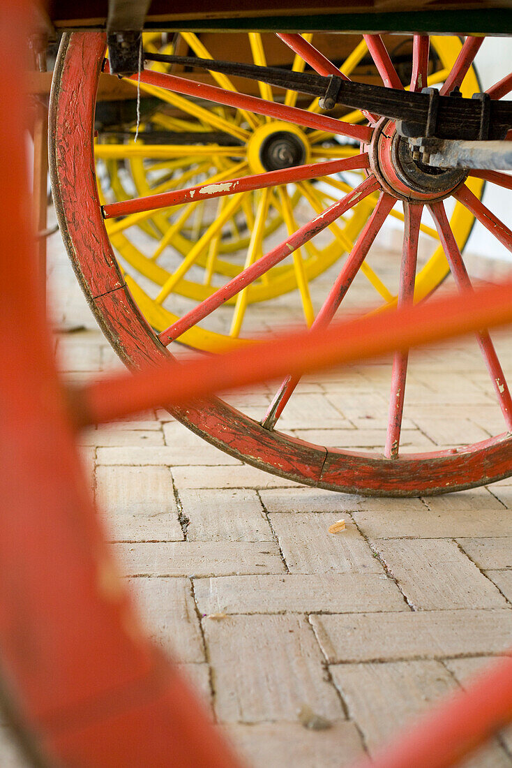 Red and yellow cart wheels, ethnographic museum, Museu Etnografico do Trajo Algarvio, Sao Bras de Alportel,  Algarve, Portugal