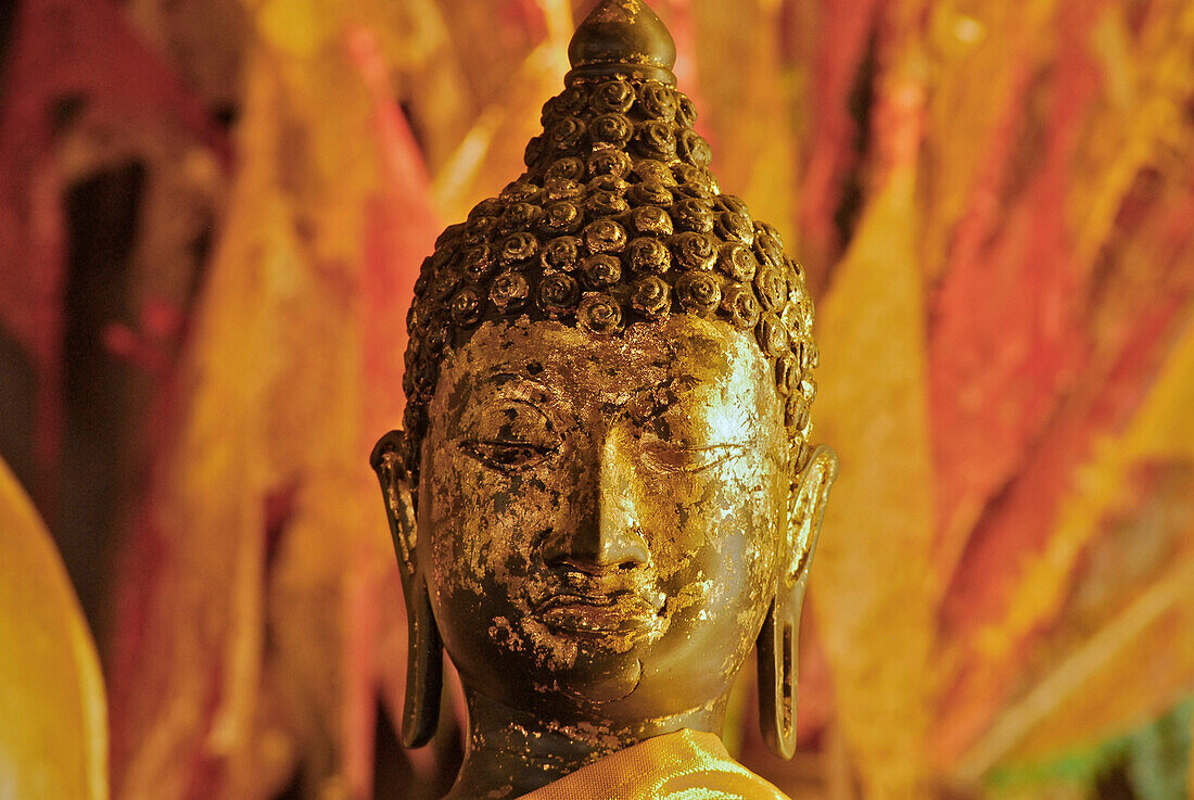Buddha in front of flags, Wat Phan Tao, Wihan, Chiang Mai, Thailand, Asia