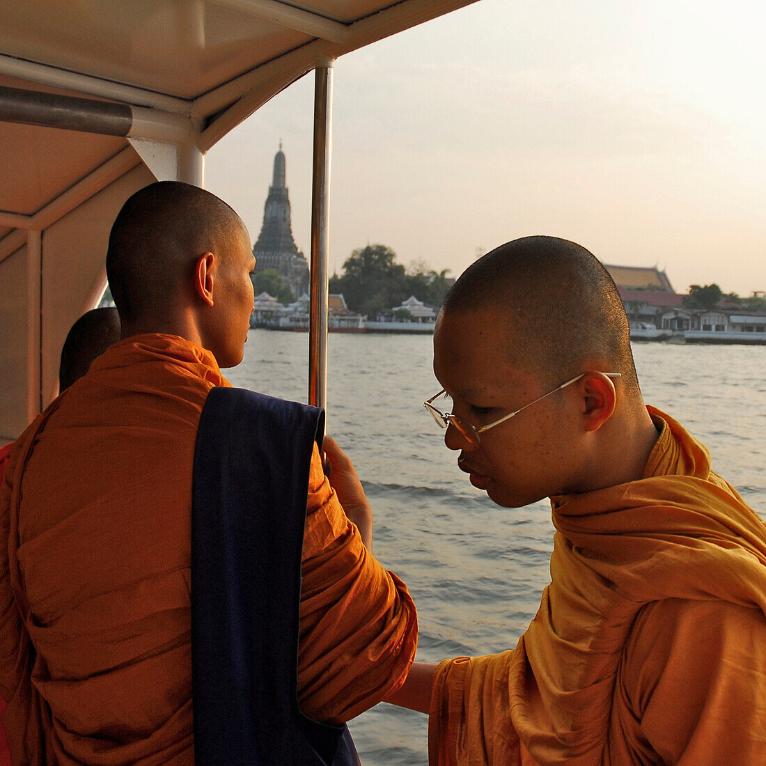 Monks on ferry in front of Wat Arun, Bangkok, Thailand, Asia
