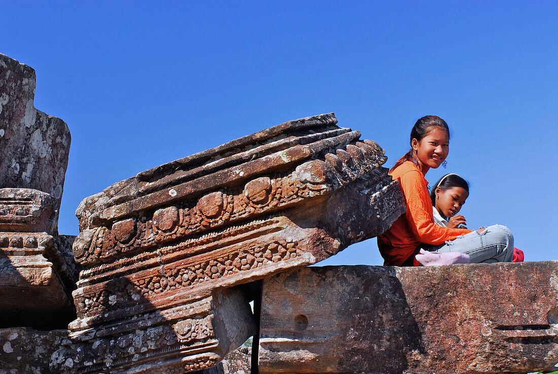 Two Cambodian girls visiting temple ruins on cambodian side, Prasat Khao Phra Wihan or Preah Vihar, cambodian name, historical site disputed between Thailand and Cambodia, Asia