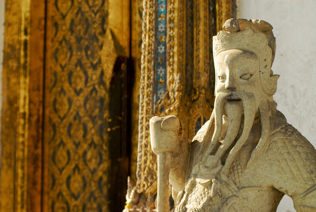 Chinese guardian figure in front of temple door at Wat Suwannaram, Thonburi, Bangkok, Thailand, Asia