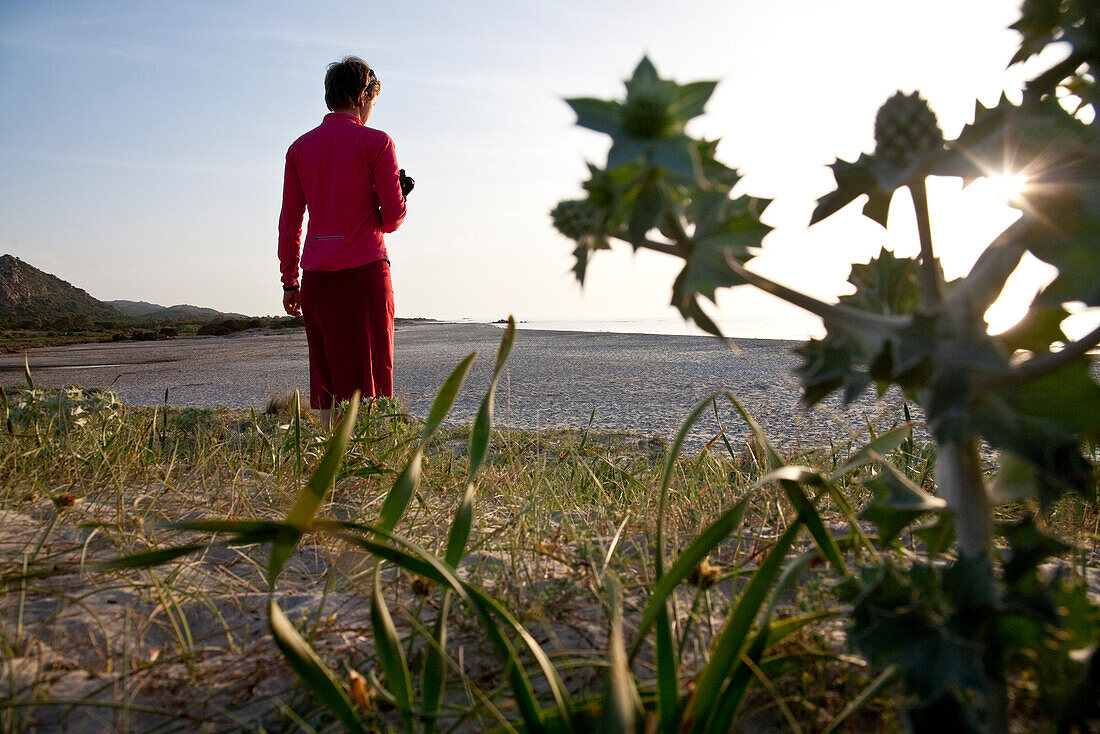 Middle-aged woman on the beach of Berchidda in the sunlight, Berchidda, Siniscola, Sardinia, Italy, Europe