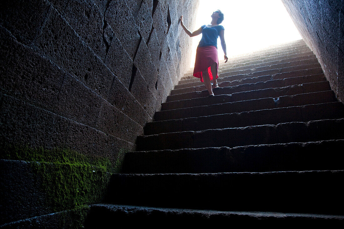 Tourist on the stairs of the sacred well temple Santa Cristina, Paulilatino, Sardinia, Italy, Europe