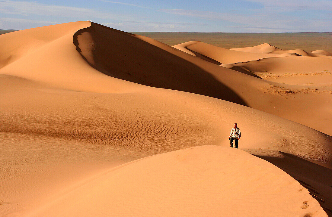 Man amongst sand dunes, Gobi Desert, Mongolia