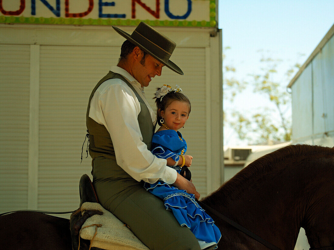 Rider with small girl in flamenco costume, Arcos de la Frontera, Andalucia, Spain