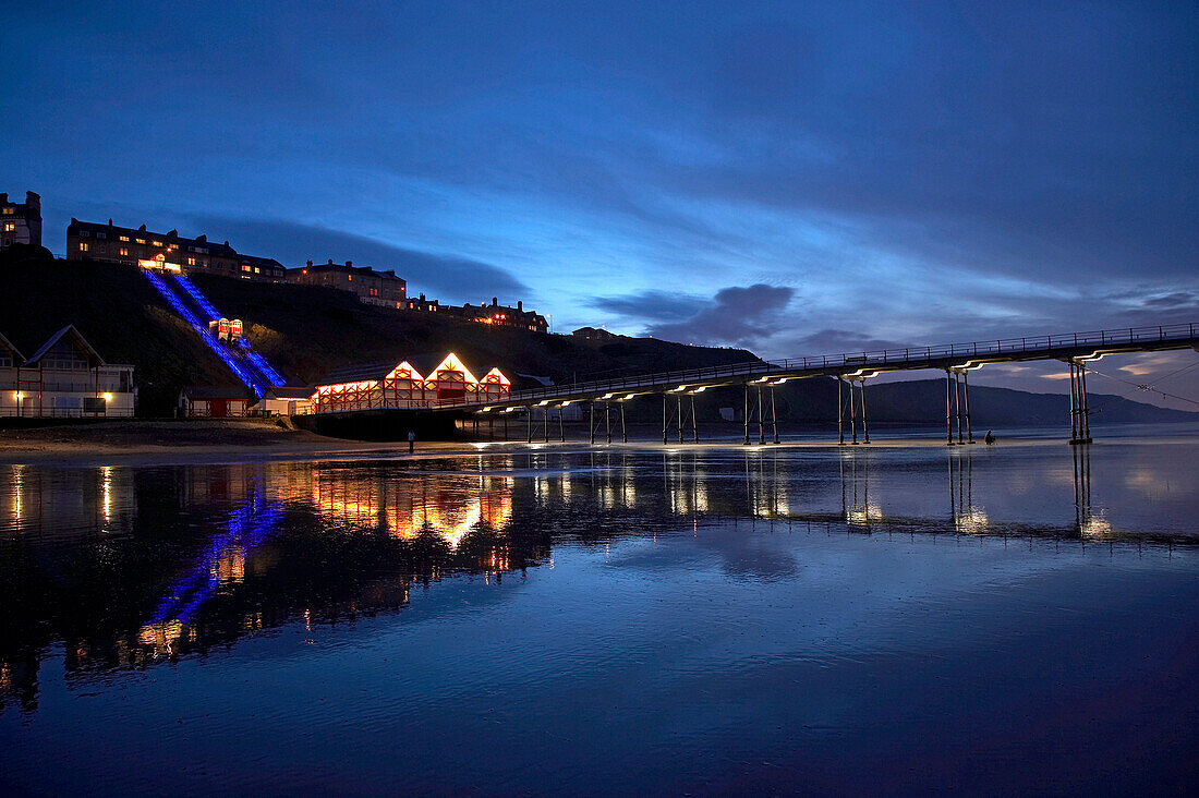 Saltburn Pier and Cliff Lift newly illuminated at night, Saltburn, Cleveland, UK, England