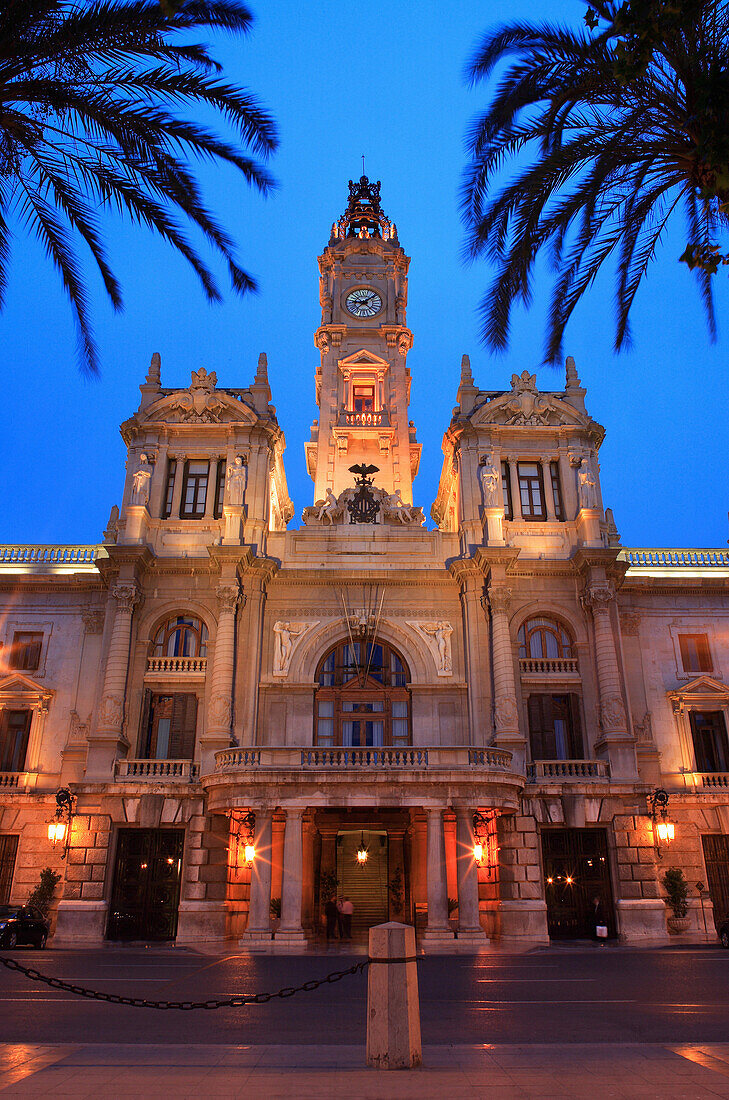 Plaza Ayuntamiento, the town hall at night framed by palms, Valencia, Valencia Region, Spain