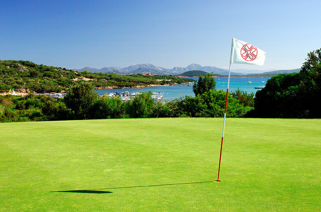 View of bay over golf club green, Porto Pevero, Sardinia, Italy