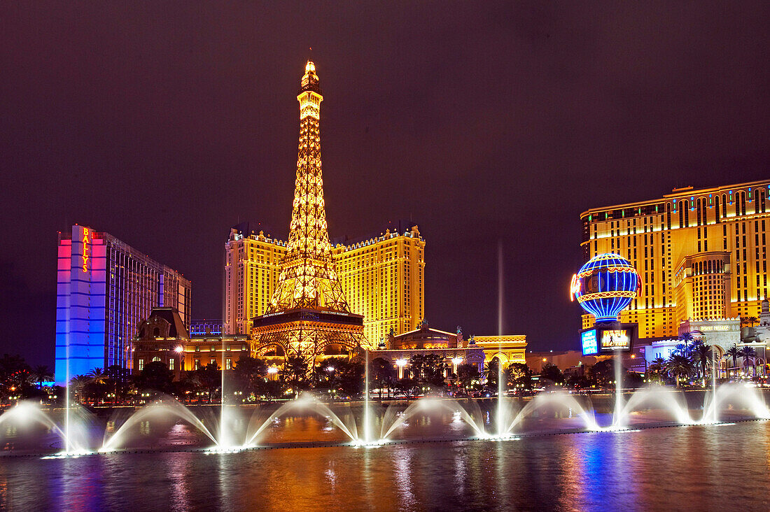 Paris Hotel and Casino with fountains playing at night, Las Vegas, Nevada, USA
