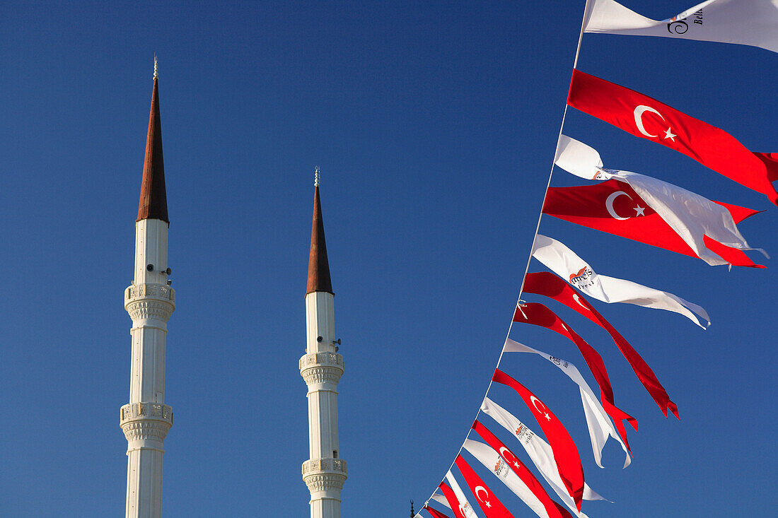 Minarets of mosque and flags, Turgutreis, Aegean, Turkey