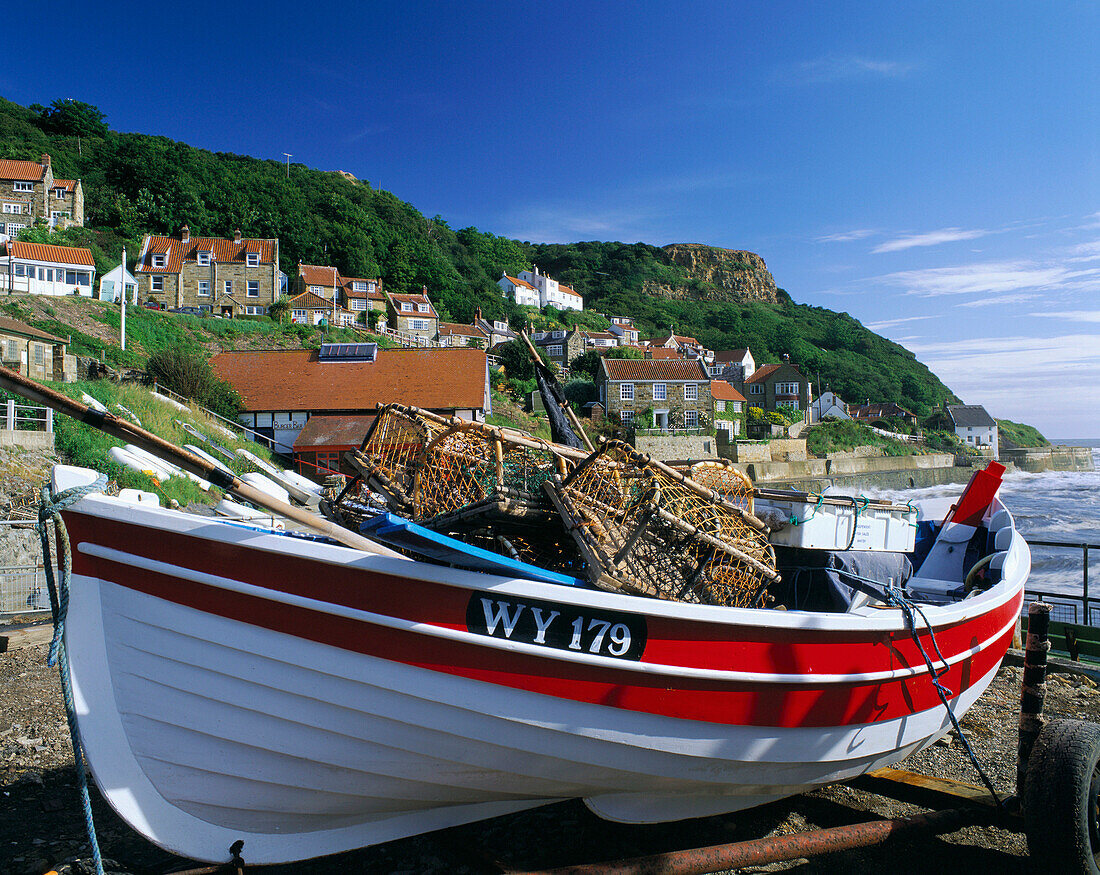 Fishing village with boat on beach, Runswick Bay, Yorkshire, UK, England