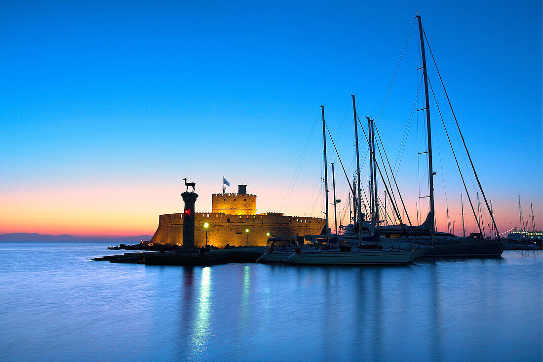 Mandraki Harbour with St Nicholas Fort at sunset, Rhodes Town, Rhodes Island, Greek Islands