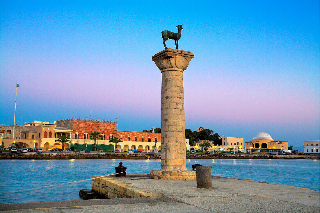 Mandraki Harbour with deer statue and St Nicholas Fort at dusk, Rhodes Town, Rhodes Island, Greek Islands