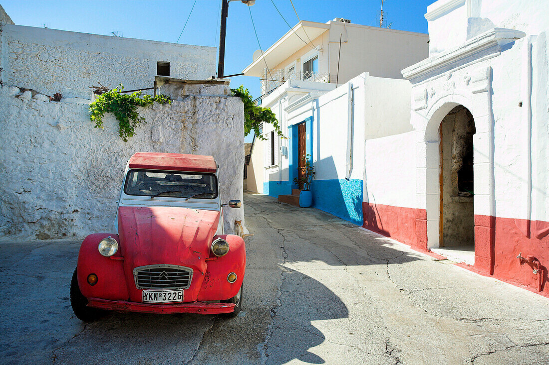Red car in quiet village street, Koskinou, Rhodes Island, Greek Islands