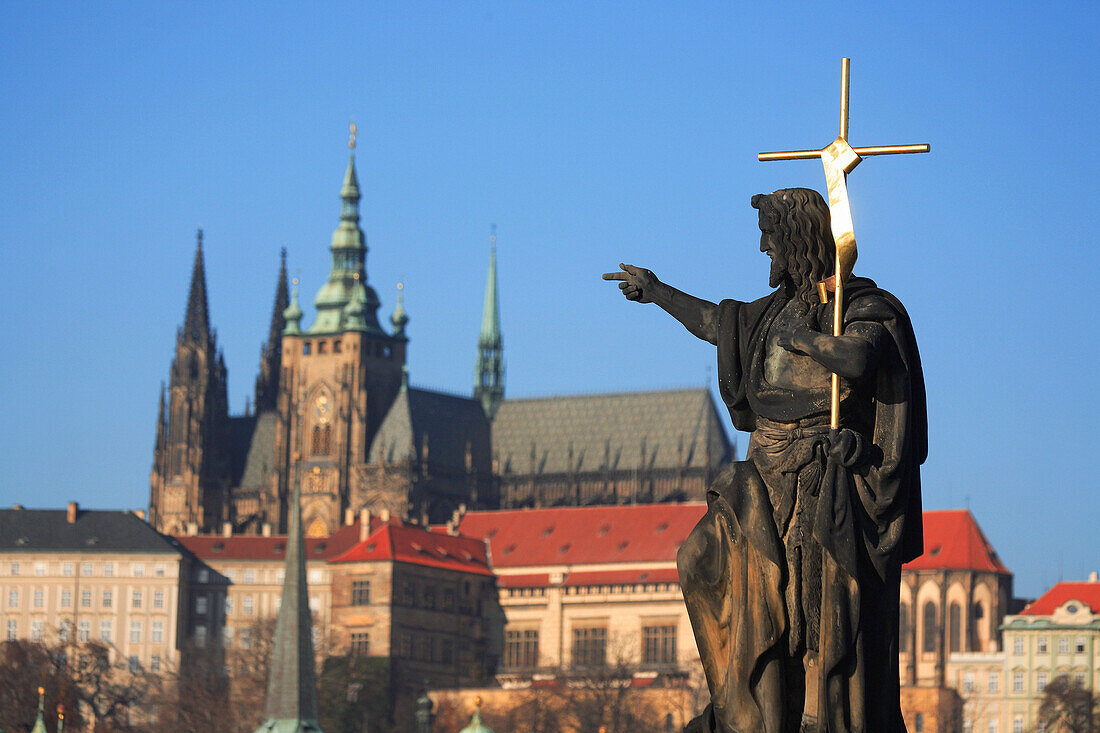 Statue on Charles Bridge with Castle and Cathedral, Prague, Czech. Republic