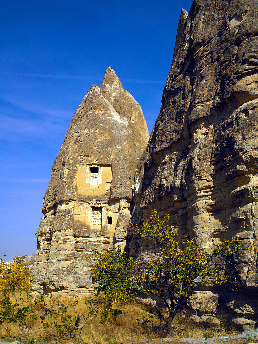 View of rock cave dwellings, fairy chimneys, Goreme, Cappadocia, Turkey