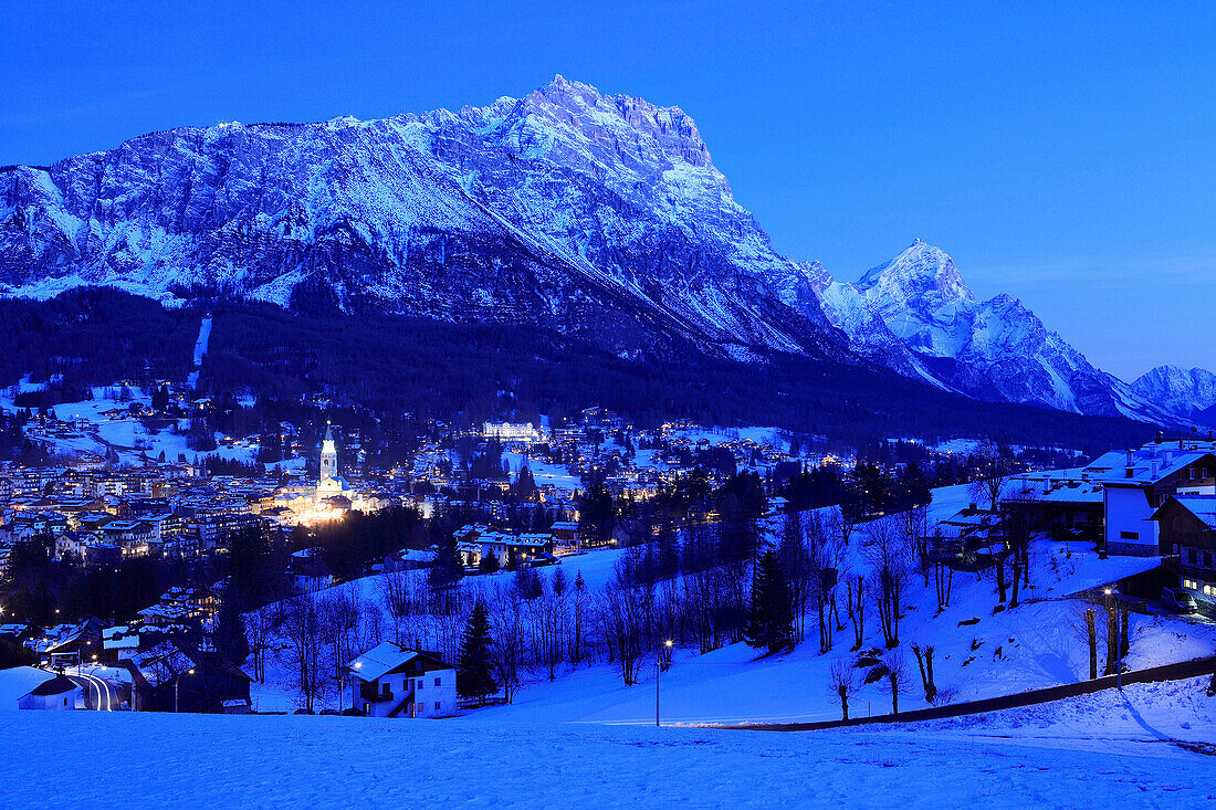 View of town and Dolomites at night in winter, Cortina d'Ampezzo, Trentino-Alto Adige, Italy