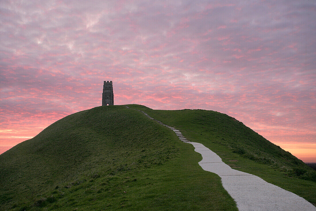 Glastonbury Tor at sunset with St Michaels Tower, Glastonbury, Somerset, UK, England