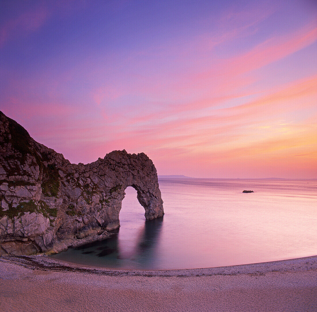 Rock arch in sea at sunset, Durdle Door, Dorset, UK, England