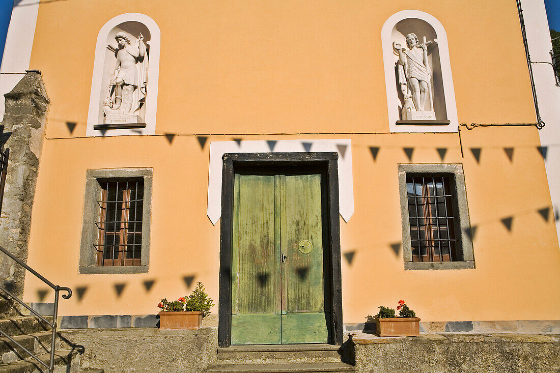 House facade with religious statues, Pignone, Liguria, Italy