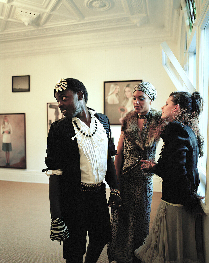 Fashion designer L. Jacobs, singer Sheba W. and singer from Ruanda at a vernissage, Peter Mc Leavey`s gallery, Cuba Street, Wellington, North Island, New Zealand