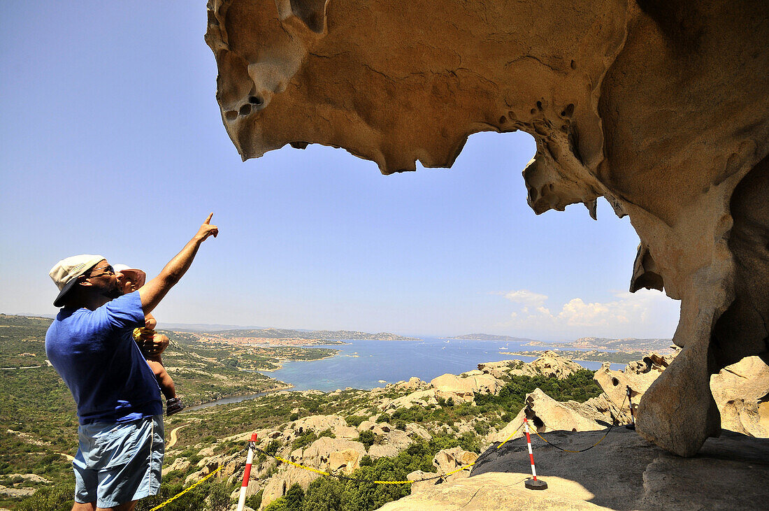 Tourists at the rock formation Capo d´Orso in the sunlight, Palau, North Sardinia, Italy, Europe