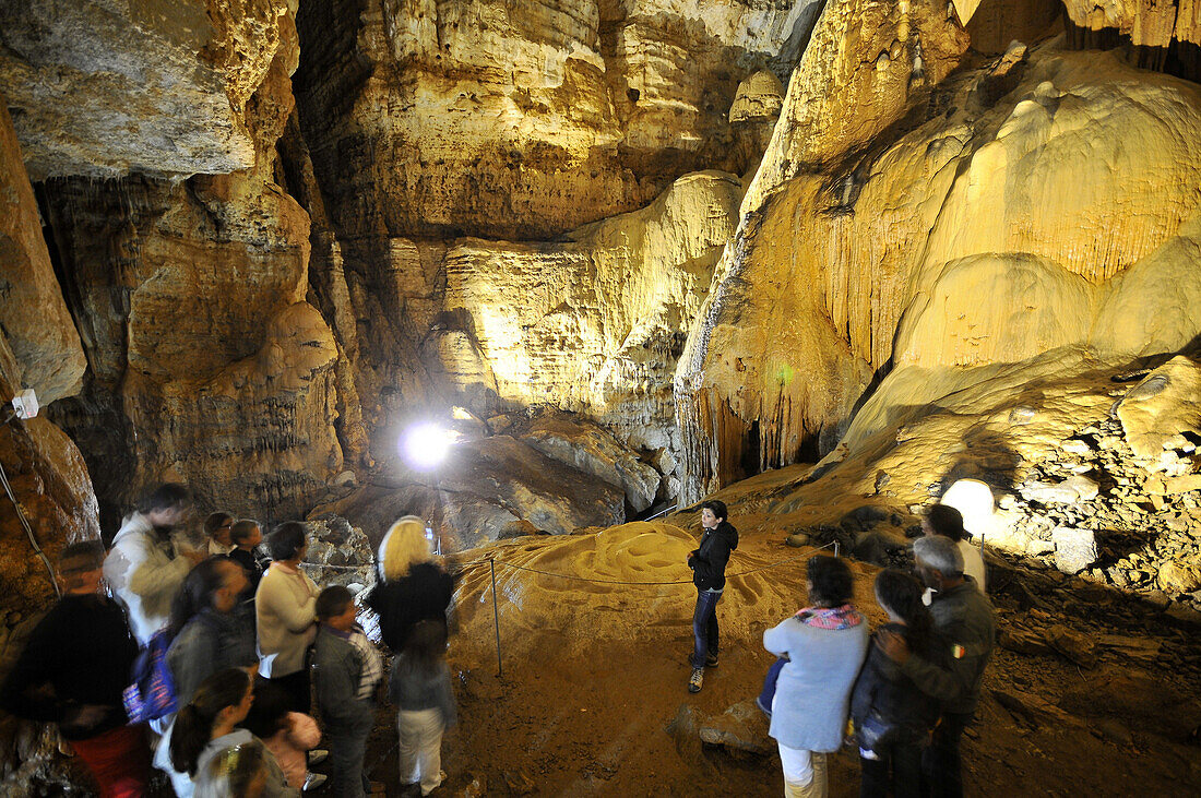 Tourists at the illuminated cave Grotta su Marmuri in the Gennargentu mountains, Sardinia, Italy, Europe