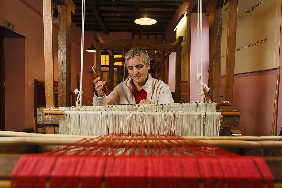 Female silk weaver sitting at a hand loom, workshop, Las Hiladeras El Paso, El Paso, La Palma, Canary Islands, Spain, Europe