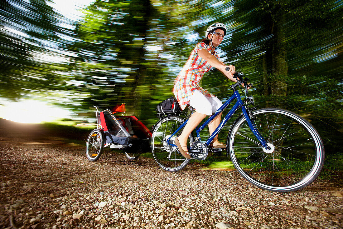 Cyclist with child trailer, Lake Starnberg, Bavaria, Germany