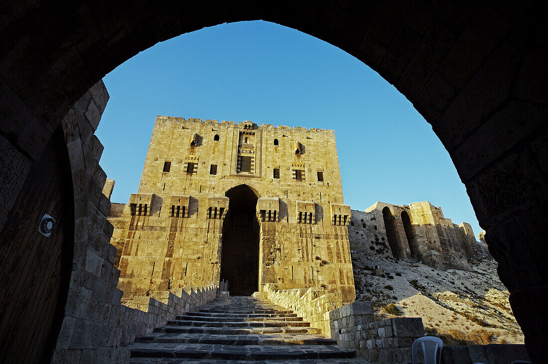 Great Citadel of Aleppo with the glacis defensive mound in the foreground and the monumental gateway and entrance,  Syria