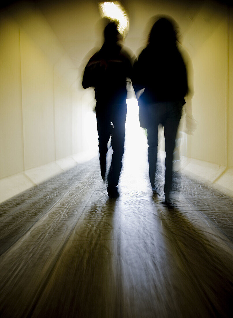 persons walking in a tunnel