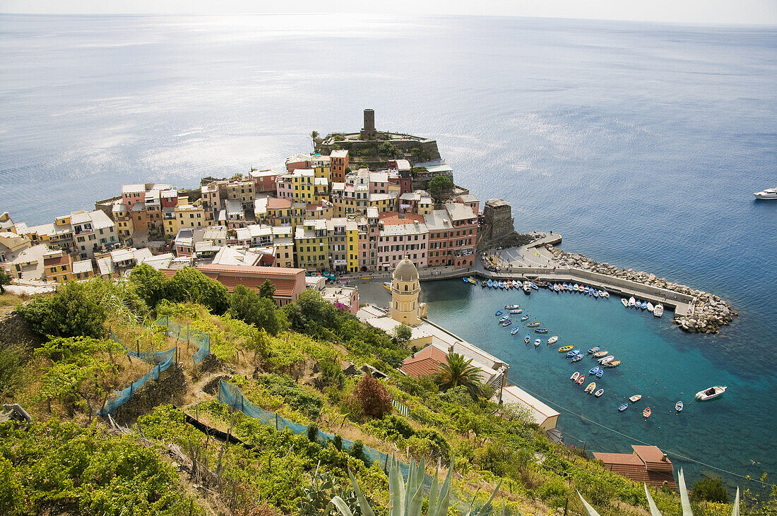 Italy,  Cinque Terre,  Vernazza.  Small town on the Italian Riviera.  One of the five villages on the famous Cinque Terre hiking trail.  Viewed from the trail on the cliffs above.