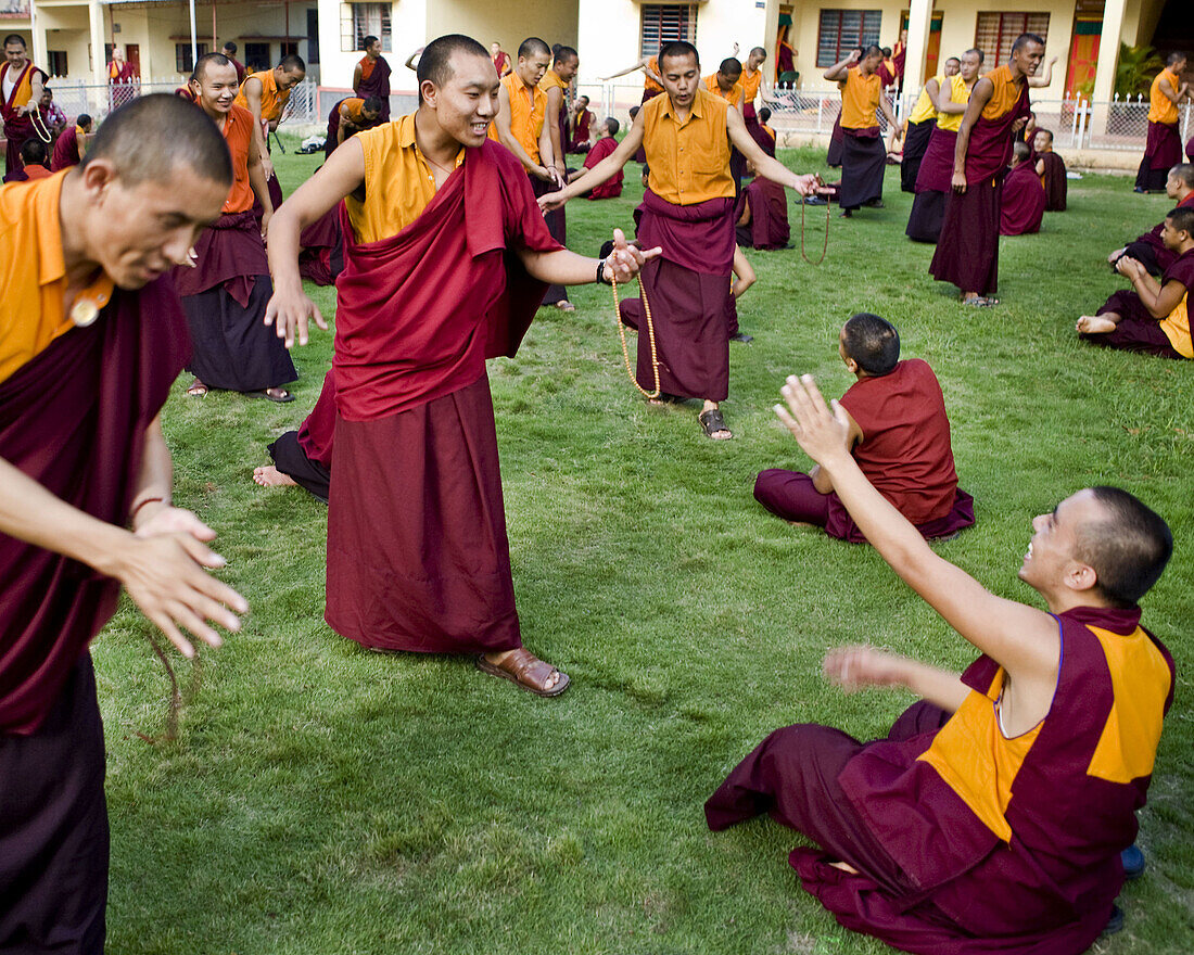 monks at practice in courtyard in india.