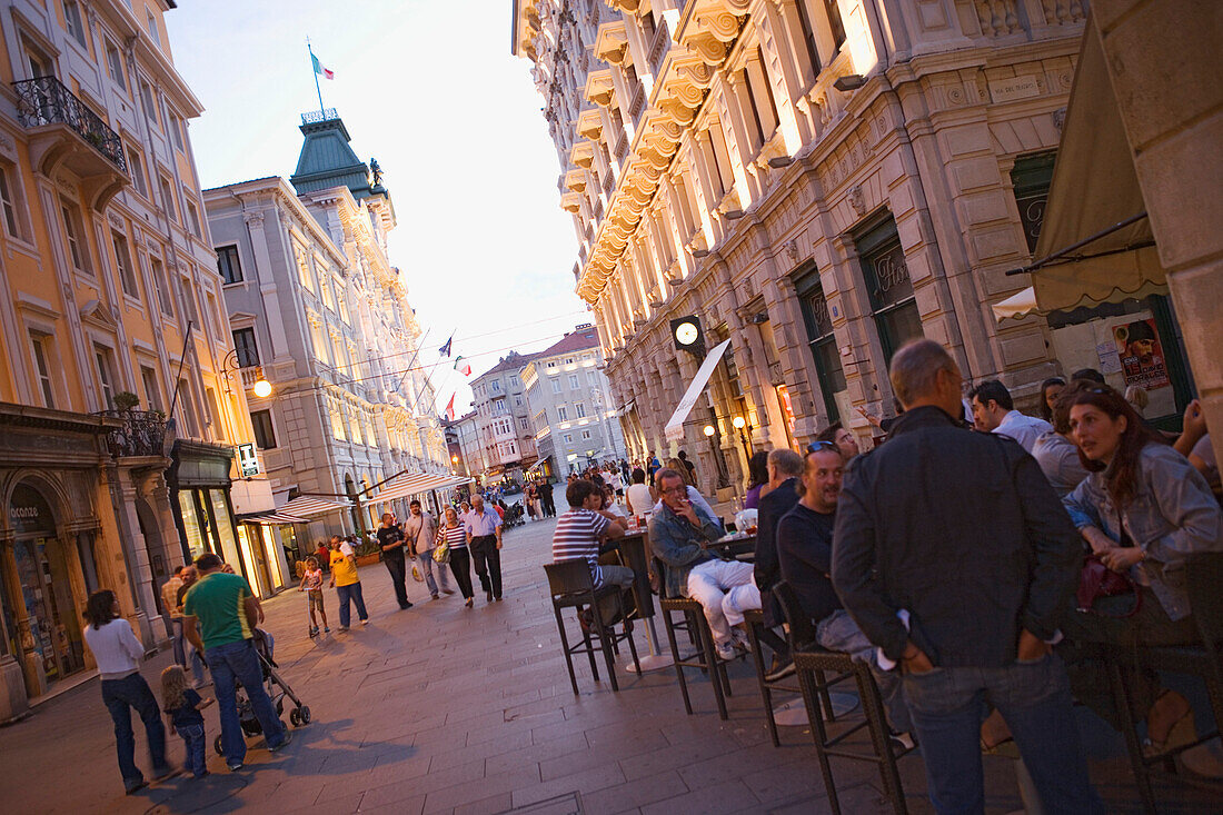 Evening on  Via del Teatro and the Piazza dell'Unita, The bar (right) is called Ex urbanis, Trieste, Friuli-Venezia Giulia, Upper Italy, Italy