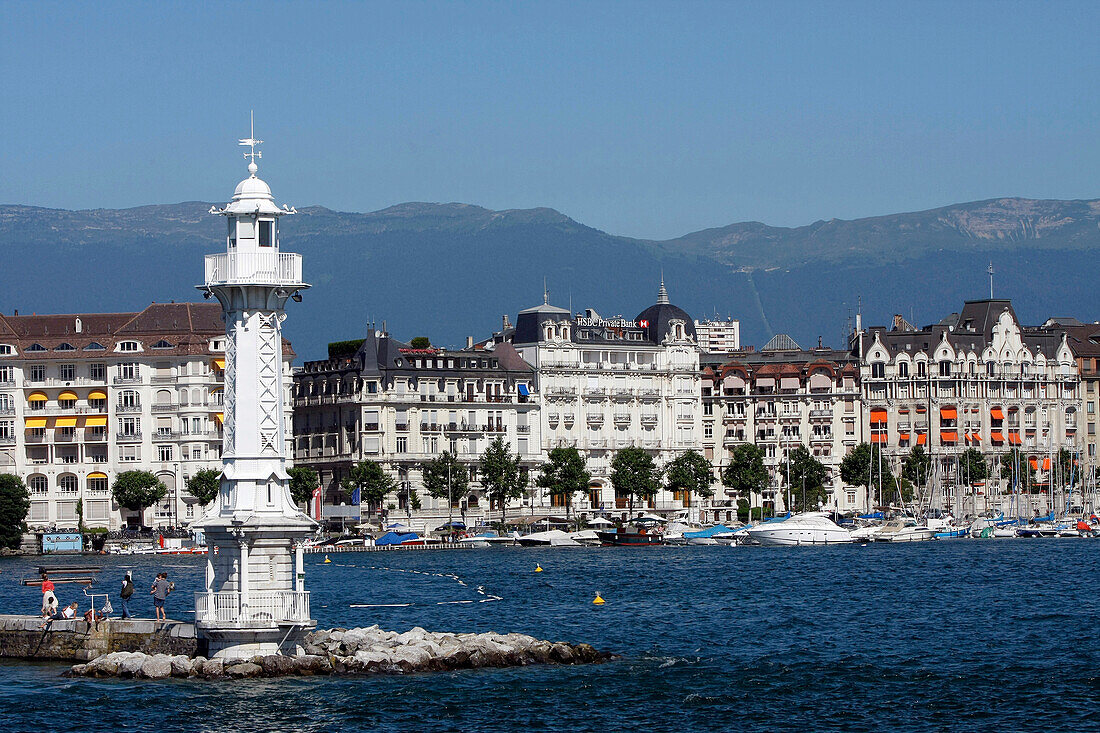 Bathing And Relaxing In Front Of The White Lighthouse Of The Bains Des Paquis In The Geneva Harbour On Lake Geneva, Switzerland