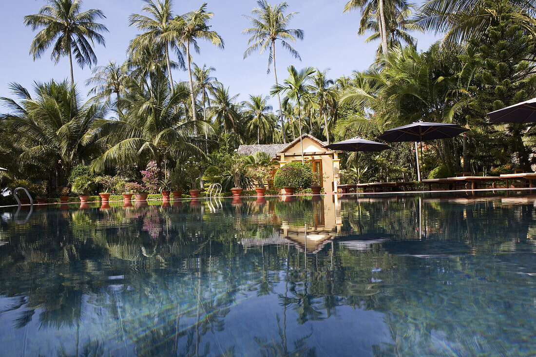 Swimming pool and tropical garden of a hotel resort in Mui Ne, Binh Thuan Province, Vietnam, Asia