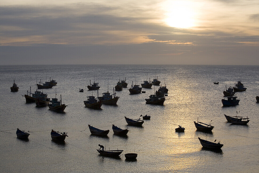 Fishing boats at Mui Ne harbour at sunset, Binh Thuan Province, Vietnam, Asia