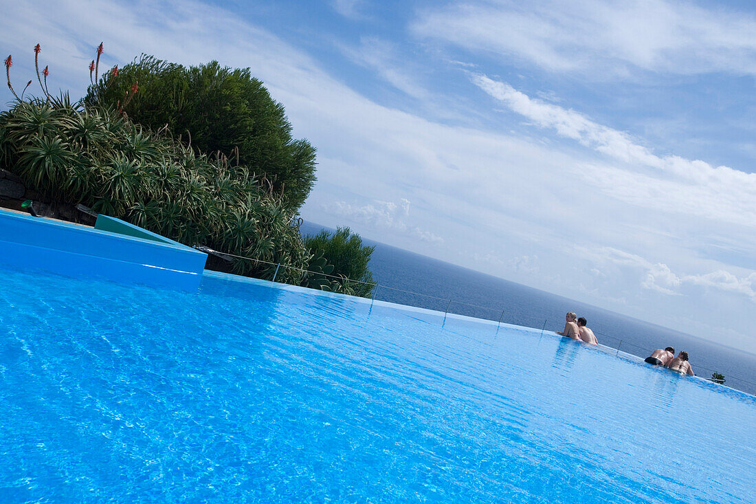 Two couples in the outdoor pool at Estalagem da Ponta do Sol Design Hotel, Ponta do Sol, Madeira, Portugal