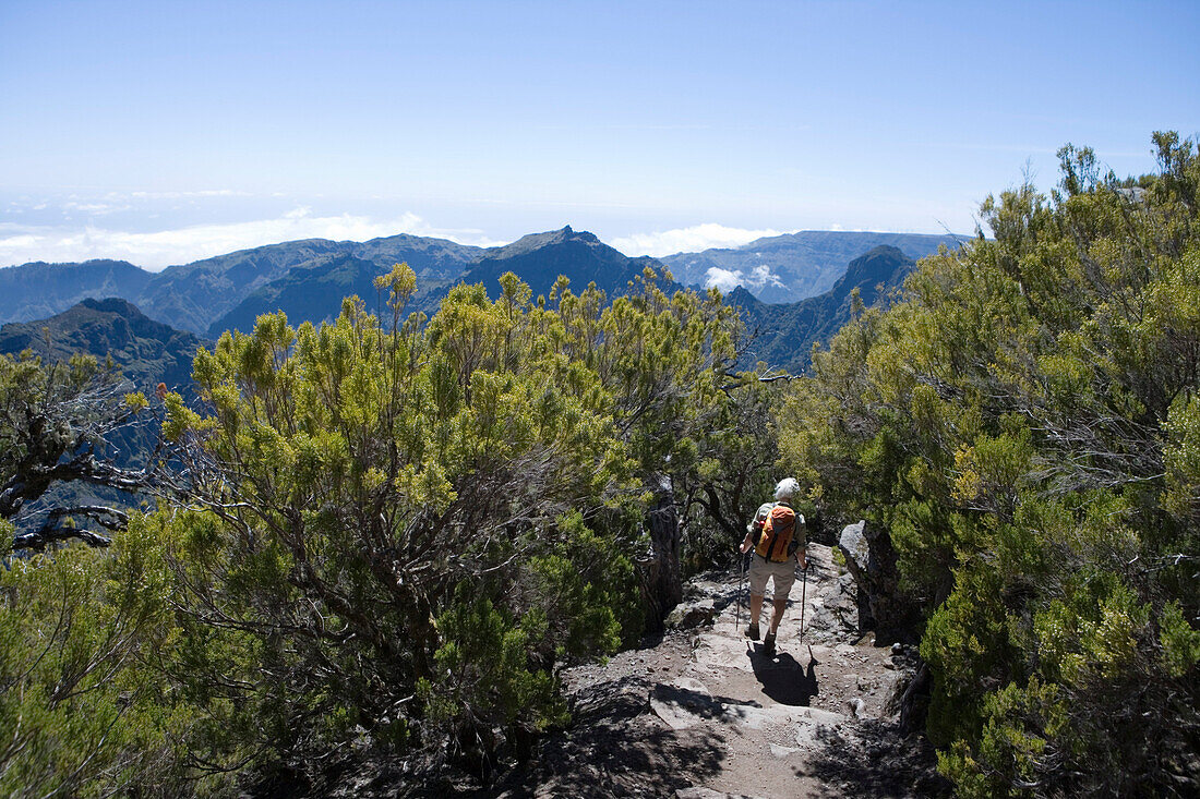 Hiker descending from the summit of Pico Ruivo Mountain, Pico Ruivo, Madeira, Portugal