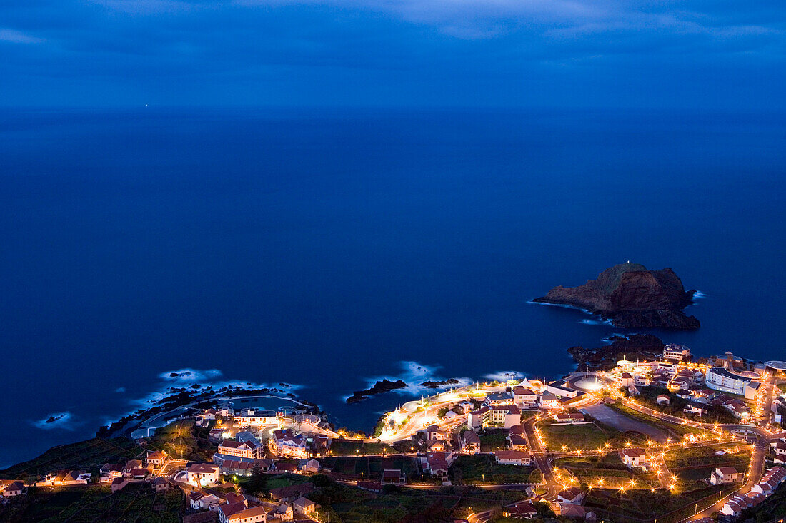 Town and Natural Rock Pools seen from Miradouro da Santinha viewpoint at dusk, Porto Moniz, Madeira, Portugal