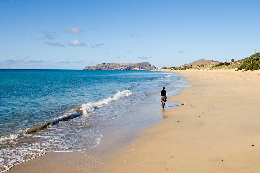 Woman strolling along Porto Santo Beach, Porto Santo, near Madeira, Portugal