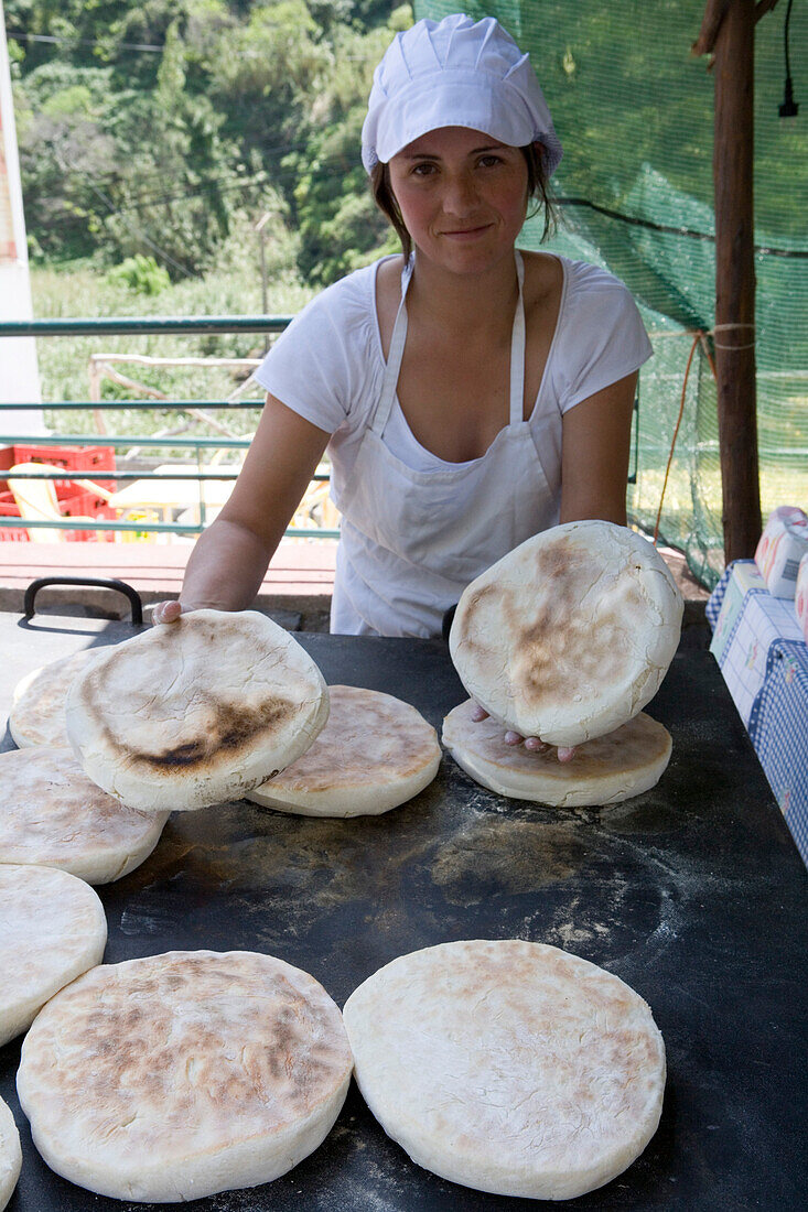 Woman baking Bolo de Caco, Flatbread, Serra de Agua, Madeira, Portugal