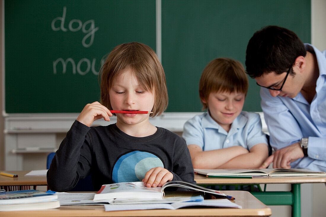 Schoolboys and male teacher in classroom, Hamburg, Germany