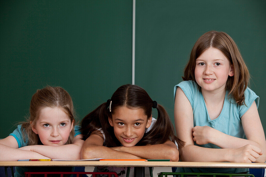 Three schoolgirls in classroom, Hamburg, Germany