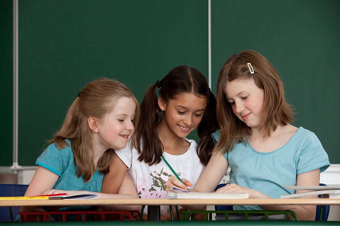 Three schoolgirls in classroom, Hamburg, Germany