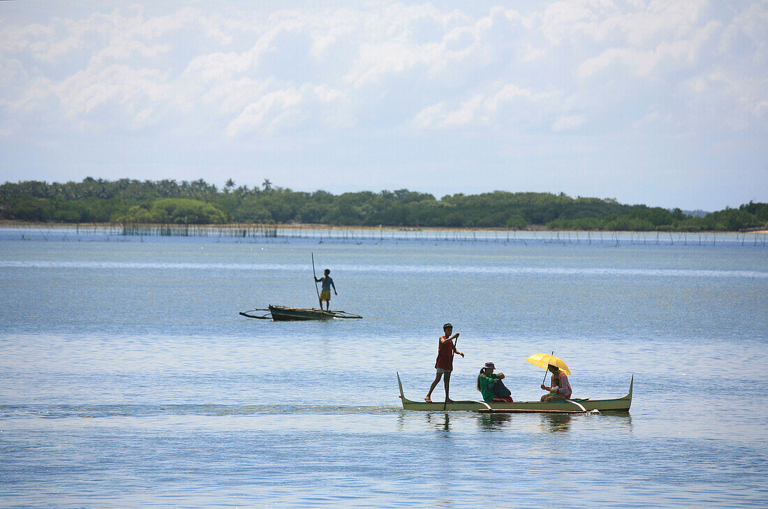 Locals in traditional outrigger boats, Bantayan, Cebu, Visayas, Philippines, Asia
