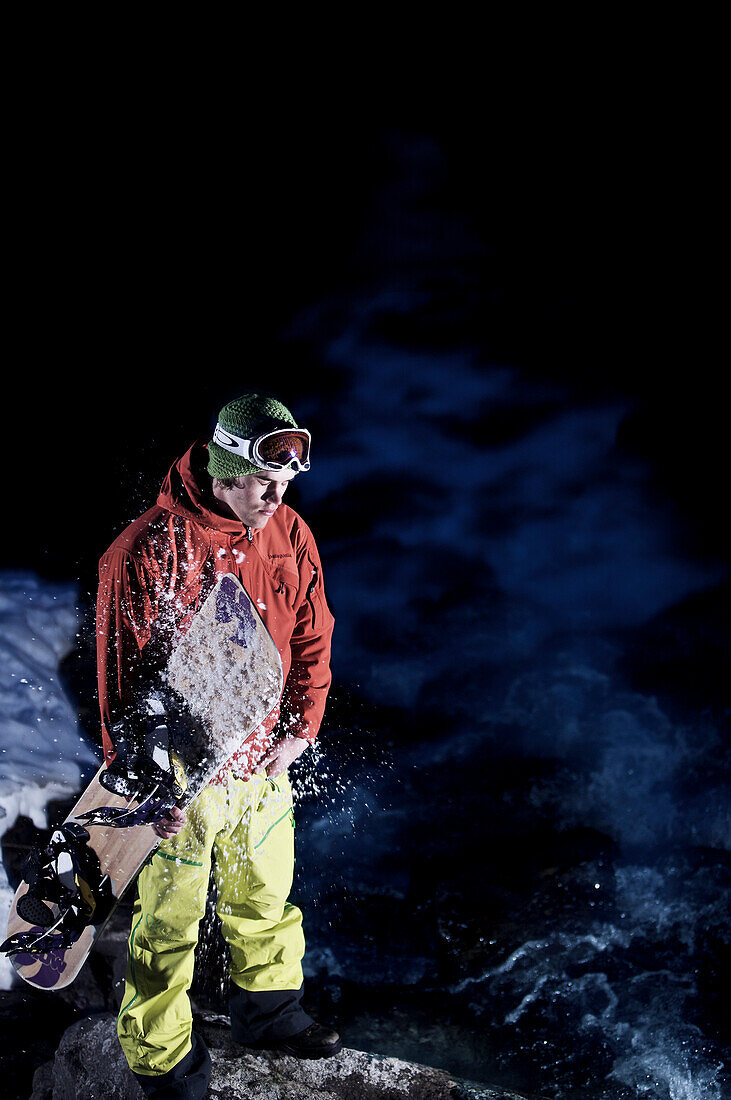 Snowboarder standing near torrent, Kappl, Tyrol, Austria