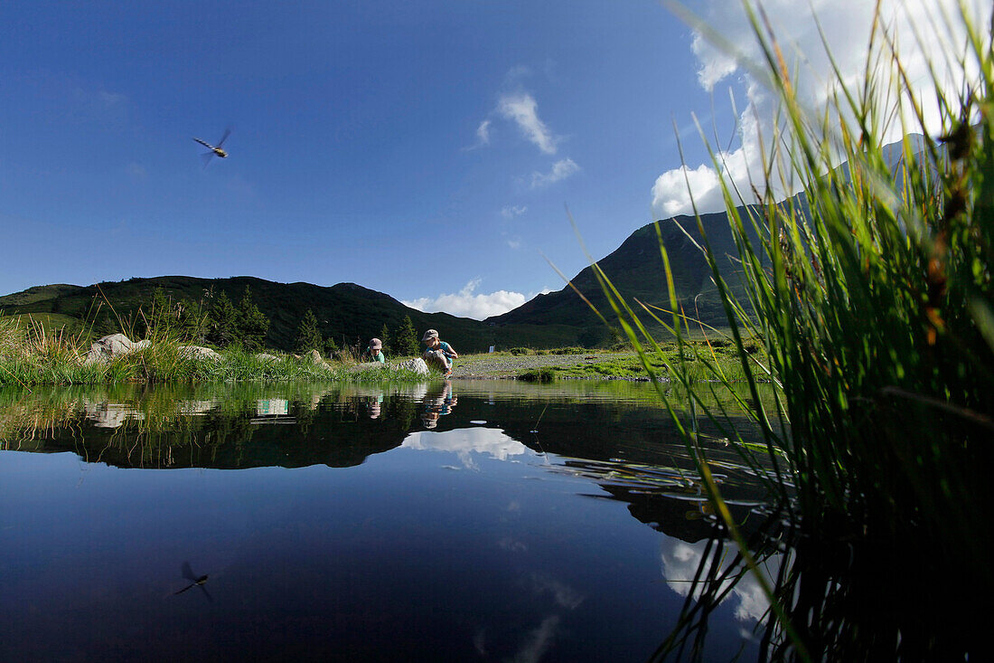 Children playing at mountain lake, Dellach, Carnic Alps, Carinthia, Austria